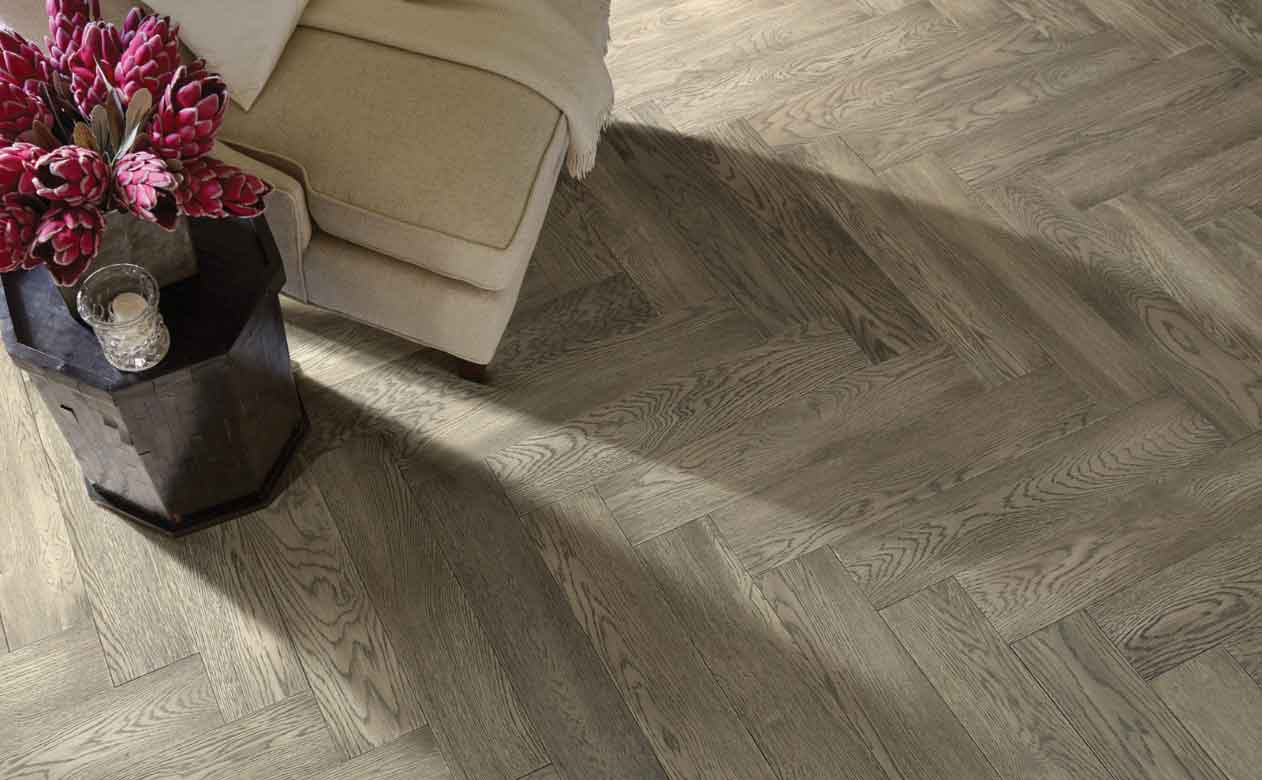 grey toned hardwood flooring in herringbone pattern in living room
